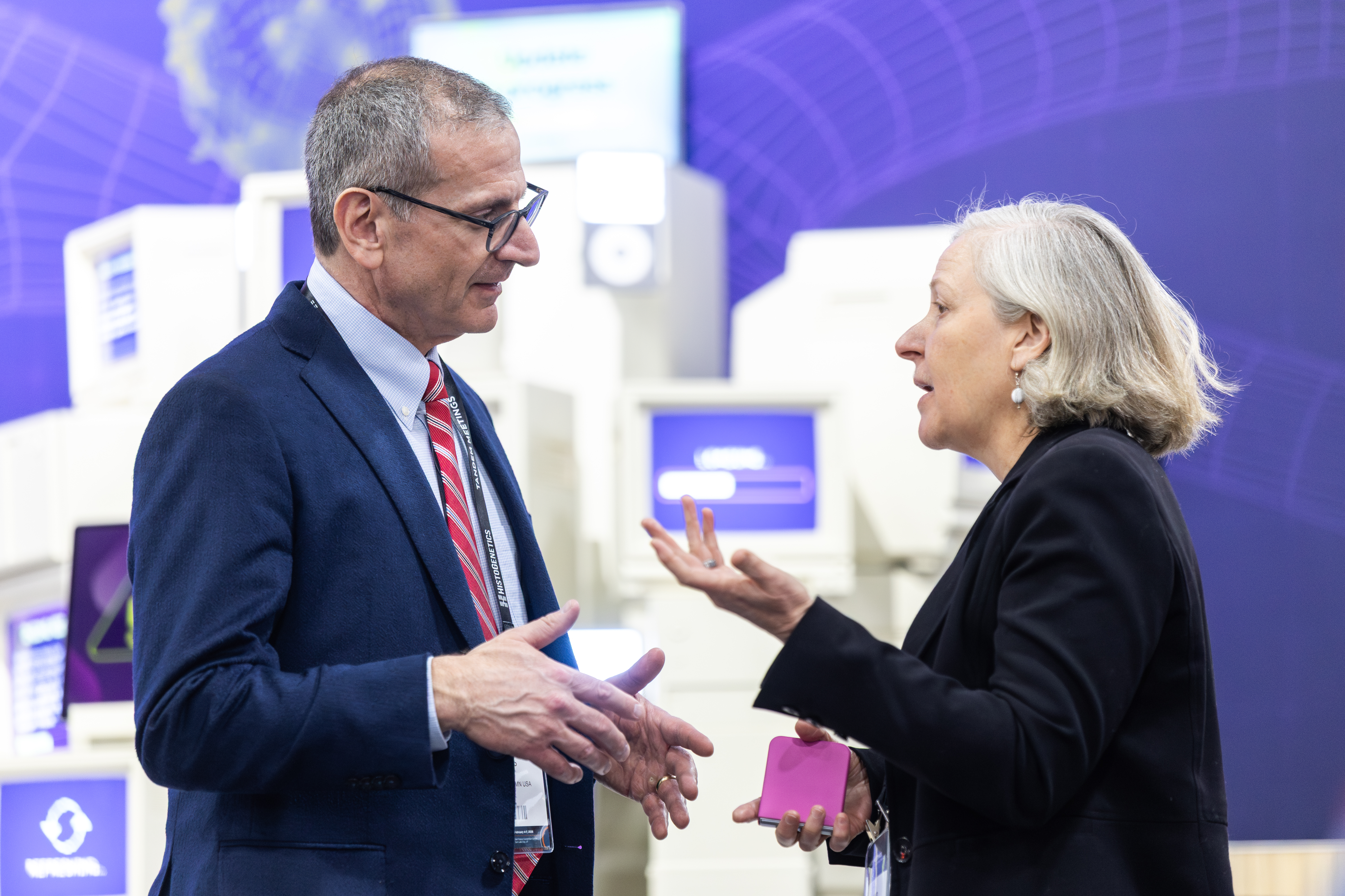 2026 attendees talk with each other in the exhibit hall.