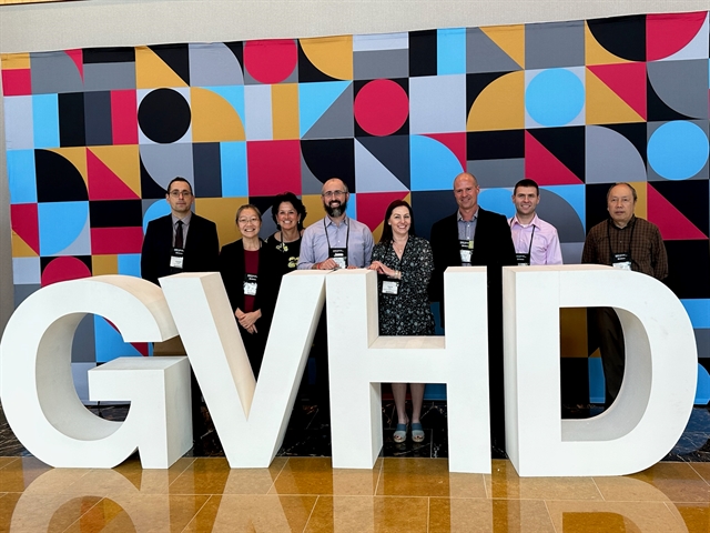 GVHD Working Committee Leadership Poses with a "GVHD" Sign