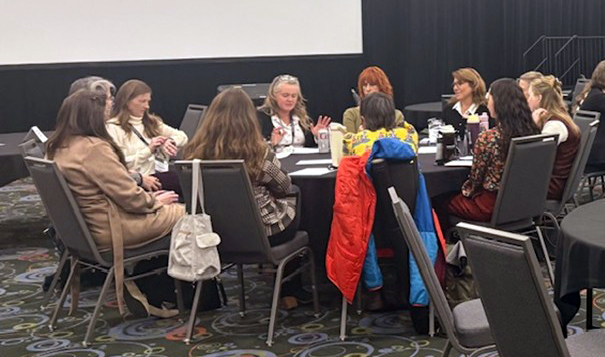 A group of attendees engaged in a conversation during the “Center Idea Sharing: Round Table” discussions