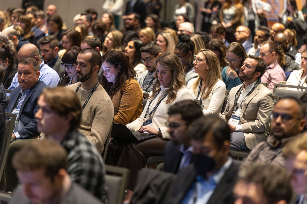 Attendees listen to a session